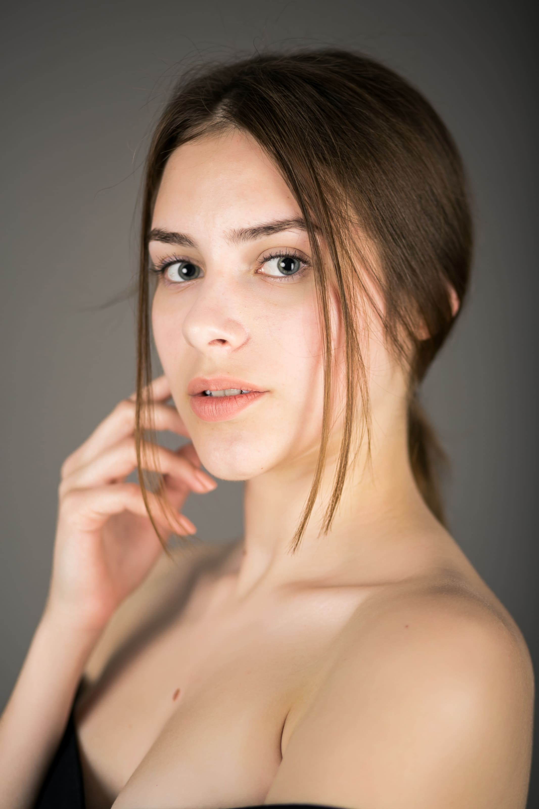 A woman applying makeup with a brush